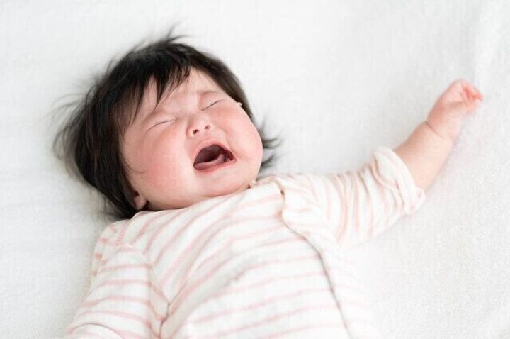 ママの膝の上であくびをする新生児の赤ちゃん10550320 の写真素材 - アフロ